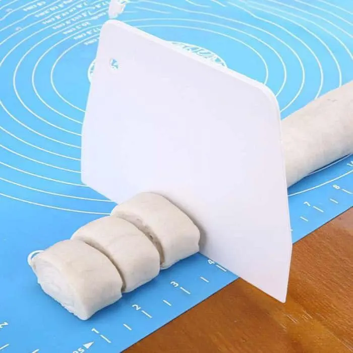 Silicone dough mat with measurements for spreading multi-colored pizza