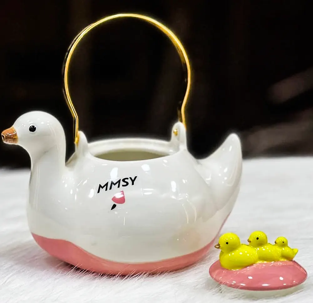 Heat-resistant porcelain teapot, duck-shaped, with a golden handle, white, model 1261